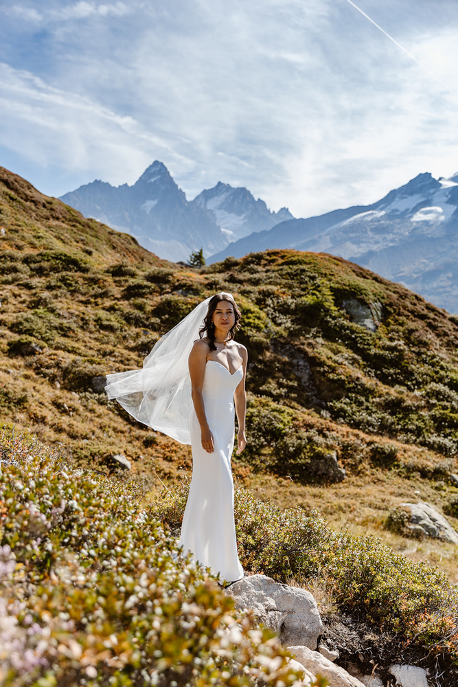 Bride portrait with veil blowing in alpine wind, Chamonix wedding photographer